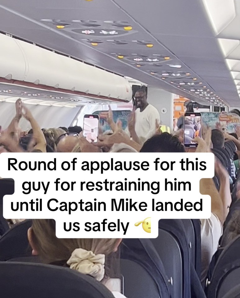 a crowd of people on an airplane applauding a man for restraining him until captain mike landed us safely