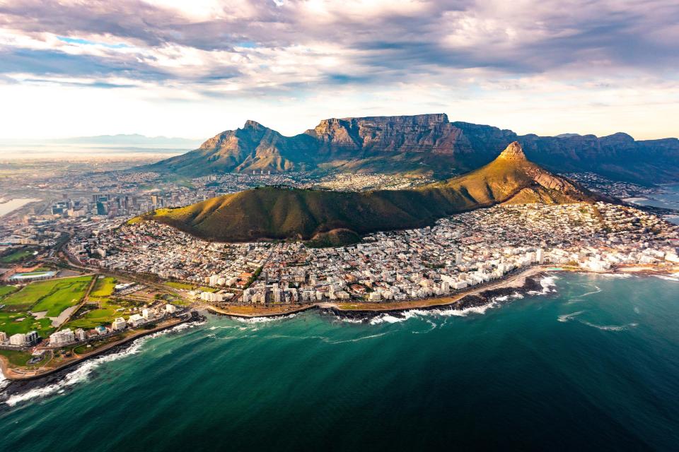 an aerial view of a city with a mountain in the background