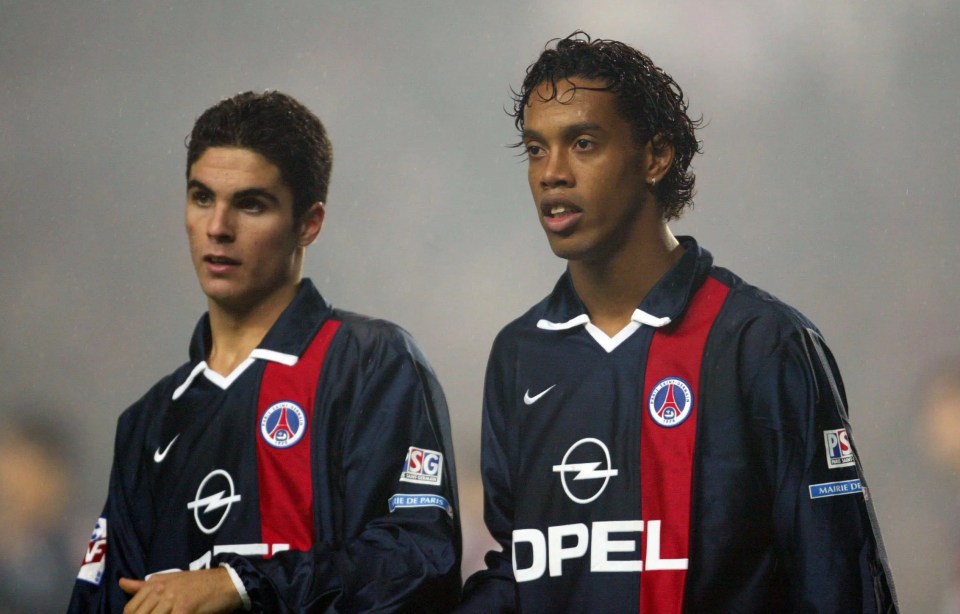 two soccer players wearing opel jerseys stand next to each other