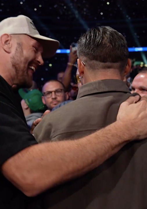 two men are hugging each other in front of a crowd