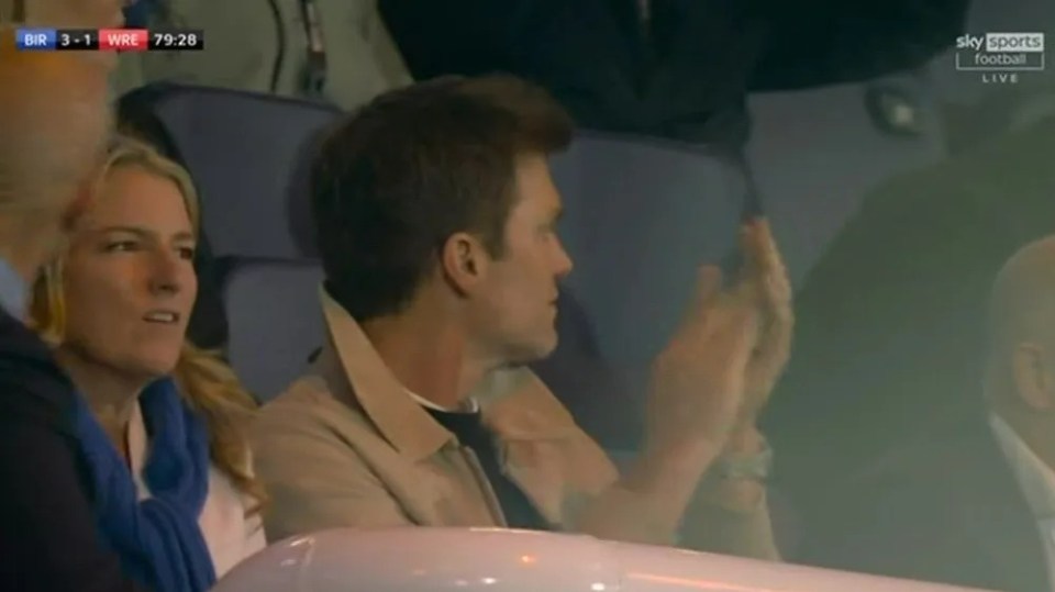 a man and woman are watching a game on sky sports