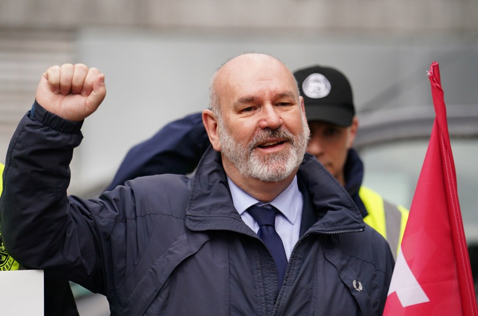 a man with a beard holds his fist in the air