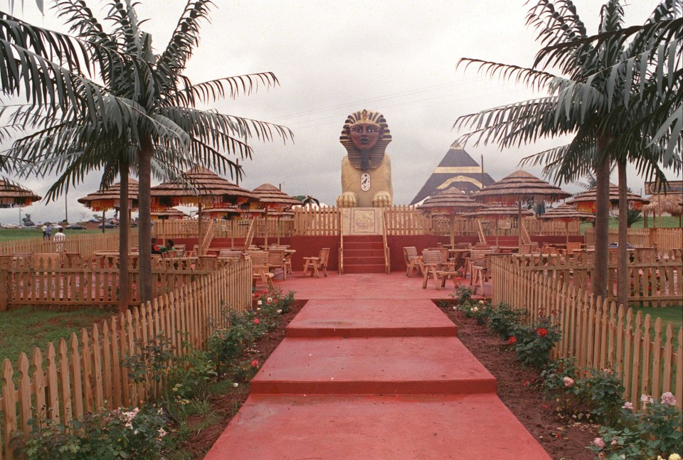 a red carpet leading to a statue of a sphinx