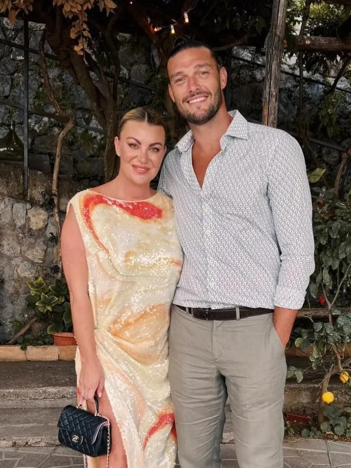 a man and a woman pose for a picture on a tiled floor