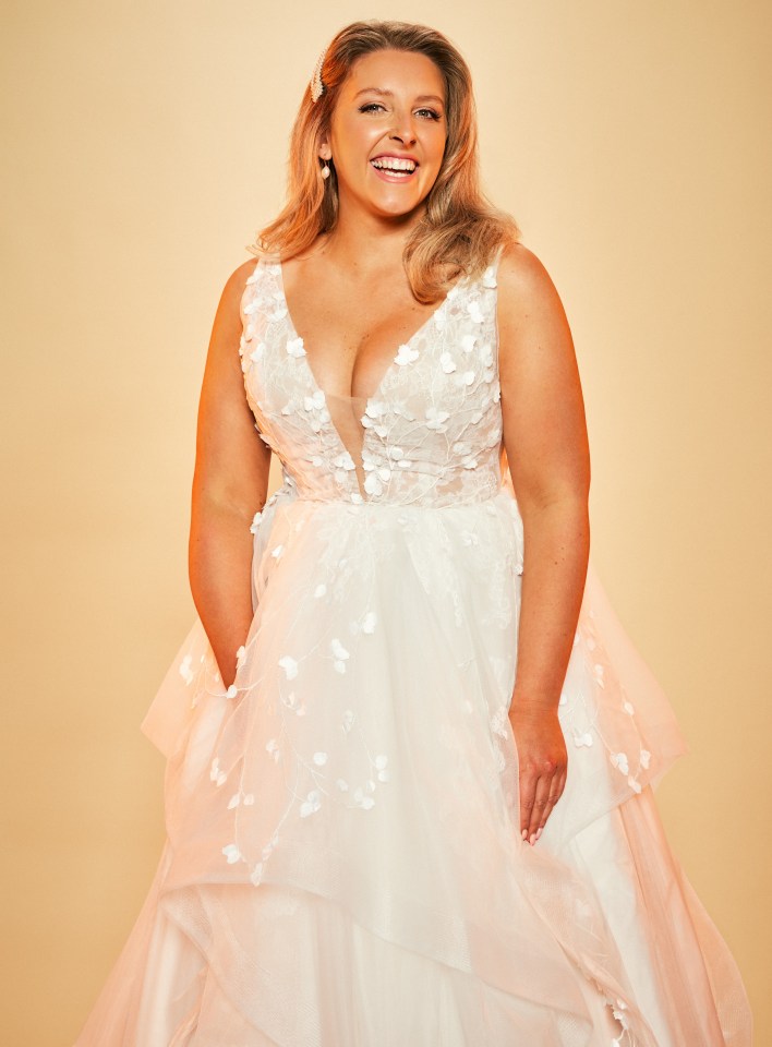 a woman in a white dress with a plunging neckline is smiling