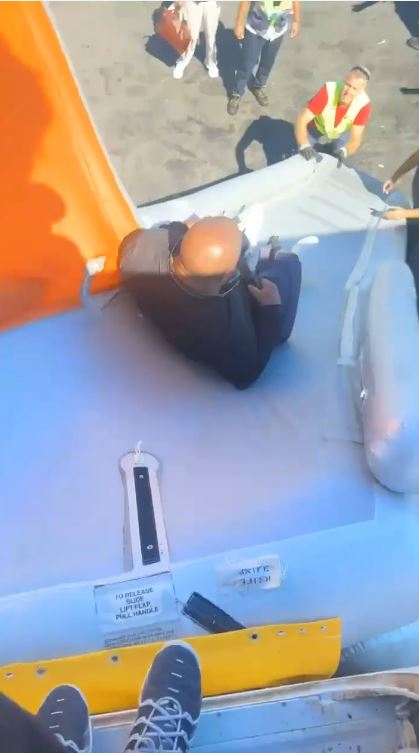 a man is sitting on top of a large inflatable raft .