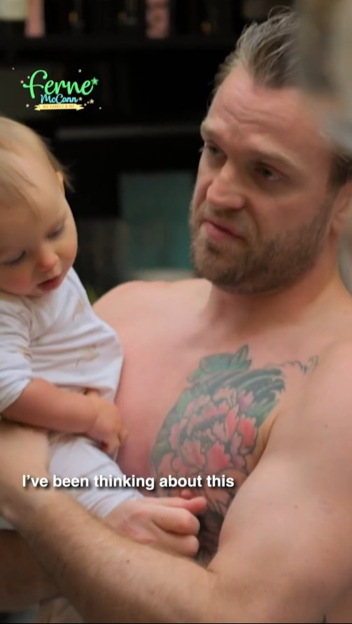 a shirtless man is holding a baby and says " i 've been thinking about this "
