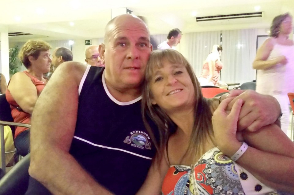 a man and woman are posing for a picture and the man is wearing a shirt that says benidorm
