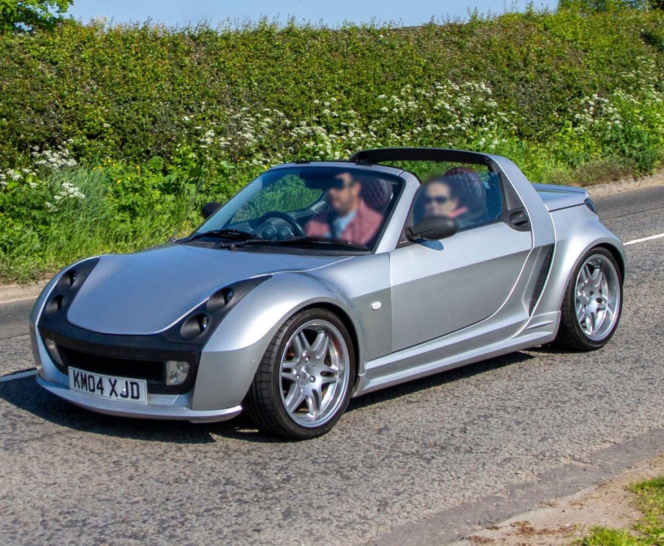 a silver car with a license plate that says km04xjd