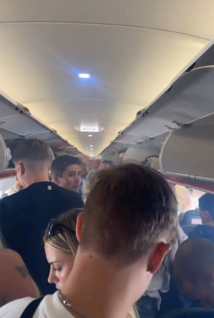 a group of people are sitting on a plane .
