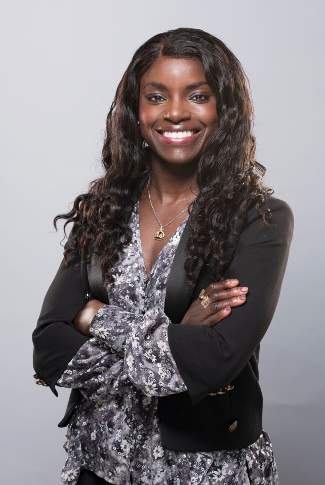 a woman with her arms crossed is smiling for the camera