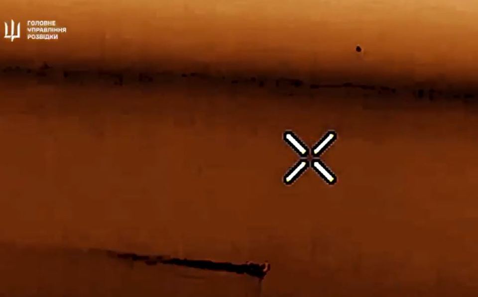 a drone is flying over a body of water with an x on it