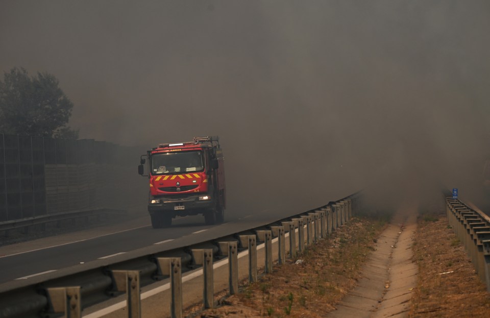 A fire truck is pictured during a forest fire that affected the hills in Quilpue, Valparaiso region, Chile, on February 3, 2024. The region of Valparaoso and Viña del Mar, in central Chile, woke up on Saturday with a partial curfew to allow the movement of evacuees and the transfer of emergency equipment in the midst of a series of unprecedented fires, authorities reported. (Photo by RODRIGO ARANGUA / AFP) (Photo by RODRIGO ARANGUA/AFP via Getty Images)