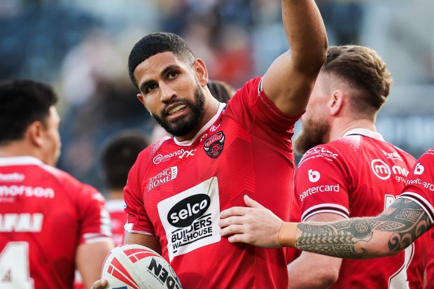 a rugby player wearing a red shirt that says selco on it
