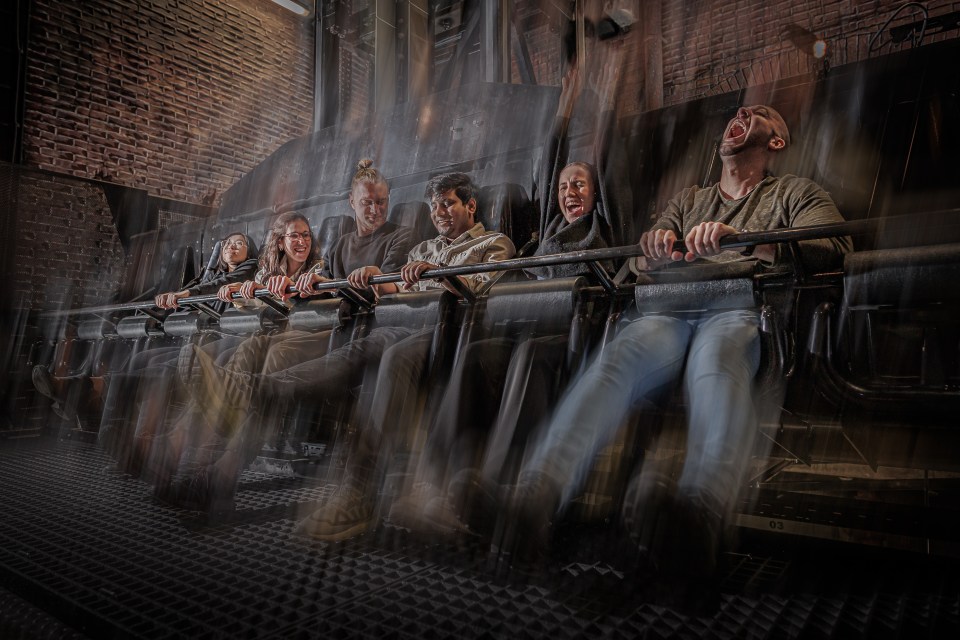 a group of people are riding a roller coaster and one of them is screaming