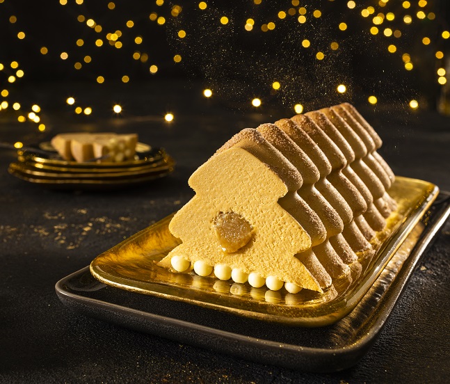 a cake in the shape of a christmas tree on a gold plate