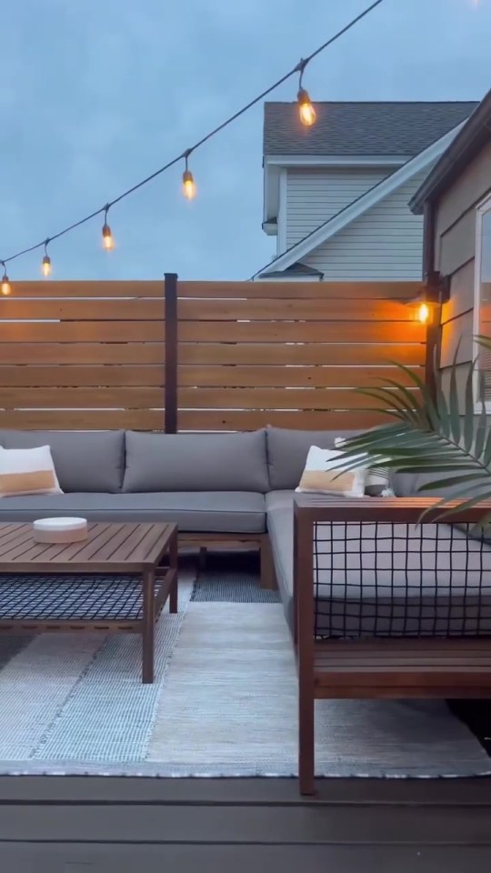 a patio area with a couch and a coffee table
