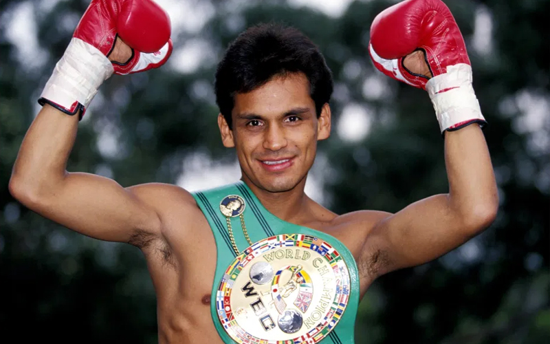 a man wearing boxing gloves and a world championship belt