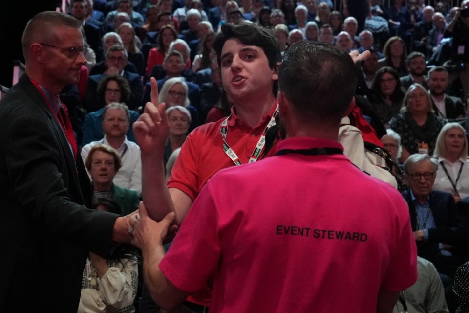 LIVERPOOL, ENGLAND - SEPTEMBER 24: A protester shouts as Britain's Prime Minister Sir Keir Starmer delivers his keynote speech during the Labour Party Conference 2024 at ACC Liverpool on September 24, 2024 in Liverpool, England. This is Labour's first conference since they were returned as the governing party of The UK and Northern Ireland by voters in the July election, ending 14 years of Conservative rule. They won with a landslide majority of 172 seats, and 412 in total. (Photo by Christopher Furlong/Getty Images)