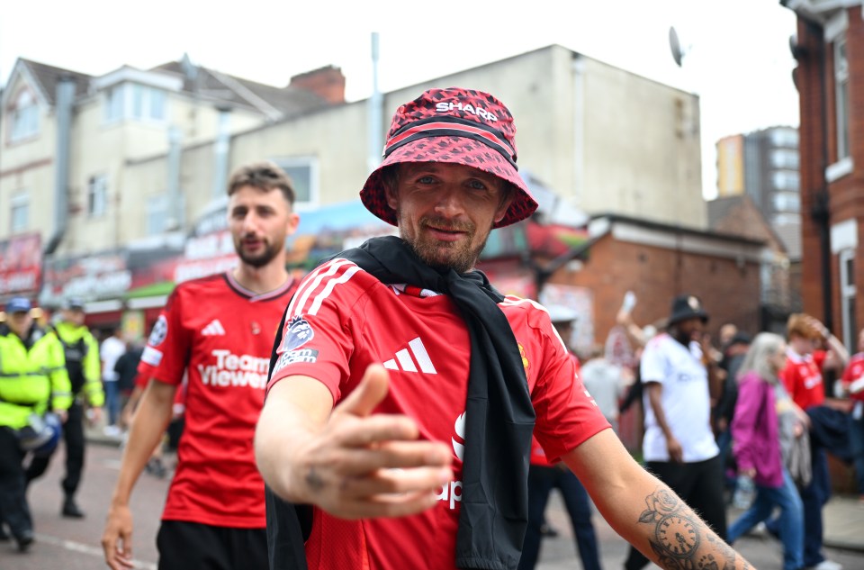MANCHESTER, ENGLAND - SEPTEMBER 01: A fan of Manchester United poses for a photo, outside the stadium prior to the Premier League match between Manchester United FC and Liverpool FC at Old Trafford on September 01, 2024 in Manchester, England. (Photo by Michael Regan/Getty Images)
