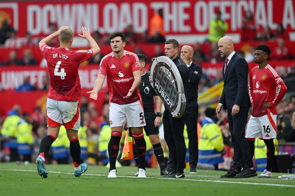 MANCHESTER, ENGLAND - SEPTEMBER 01: Matthijs de Ligt of Manchester United interacts with Harry Maguire of Manchester United, as he leaves the pit during the Premier League match between Manchester United FC and Liverpool FC at Old Trafford on September 01, 2024 in Manchester, England. (Photo by Shaun Botterill/Getty Images)