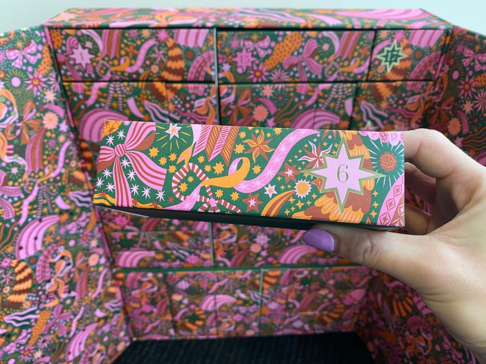 a person holding a box with the number 6 on it