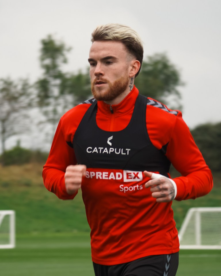 a man wearing a red vest that says catapult on it