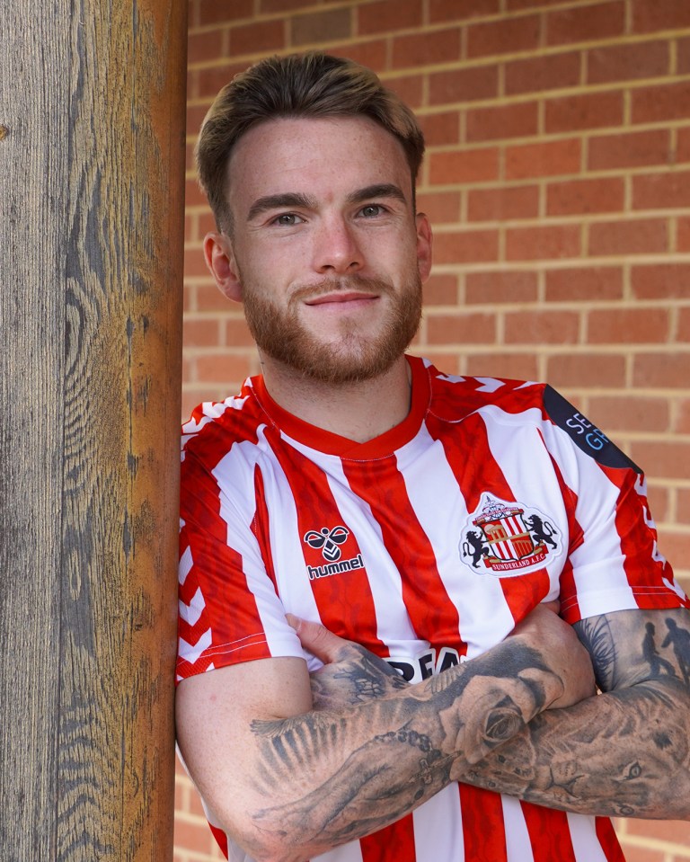 a man wearing a red and white striped shirt with the word hummel on it