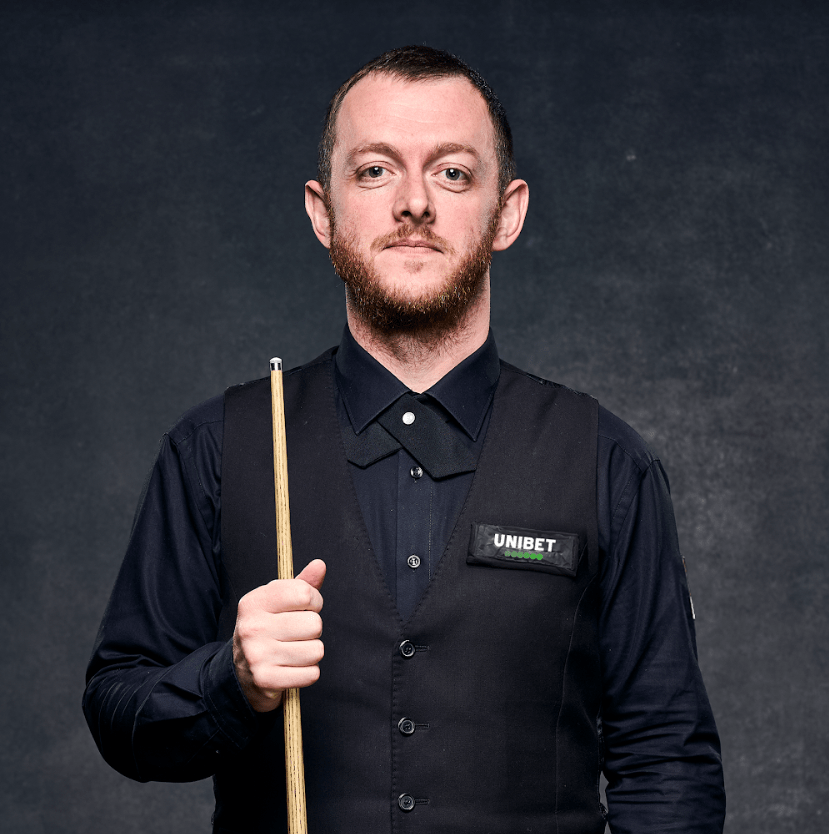 a man wearing a vest that says ' unibet ' on it