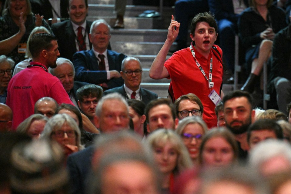 A heckler is escorted out of the auditorium as Britain's Prime Minister Keir Starmer delivers his keynote speech on the third day of the annual Labour Party conference in Liverpool, north-west England, on September 24, 2024. (Photo by Oli SCARFF / AFP) (Photo by OLI SCARFF/AFP via Getty Images)