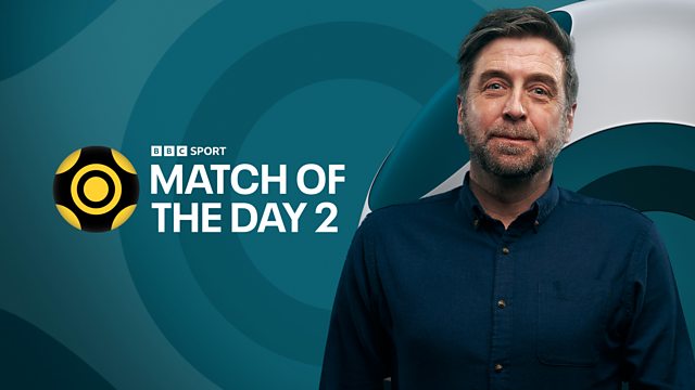 a man stands in front of a bbc sport match of the day 2 ad
