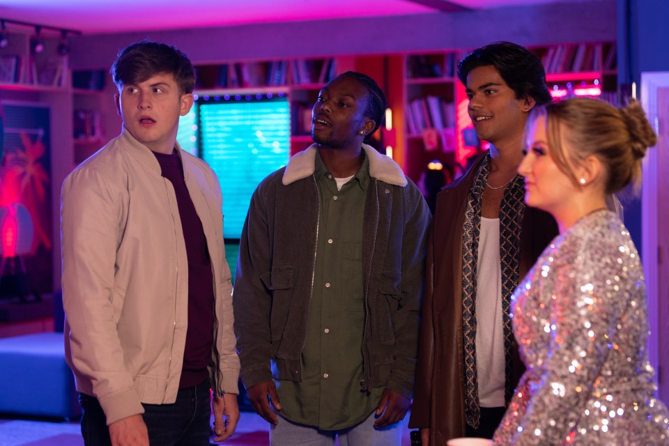 a woman in a sequined dress stands between three men