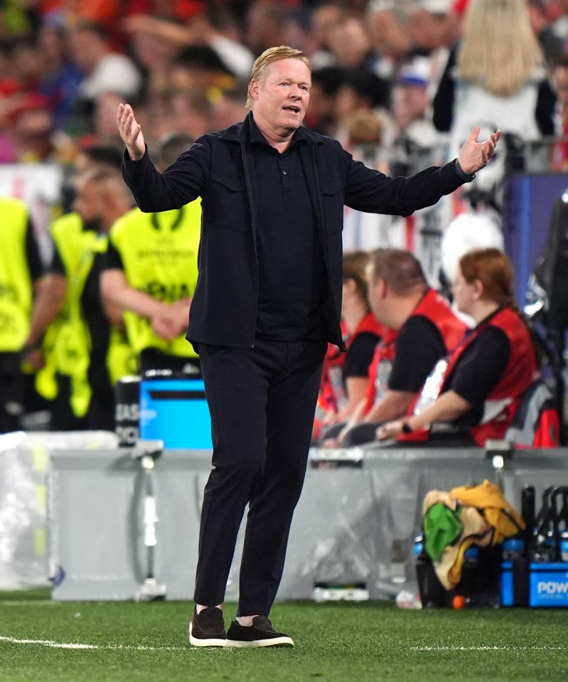 a man stands on a soccer field with his arms outstretched