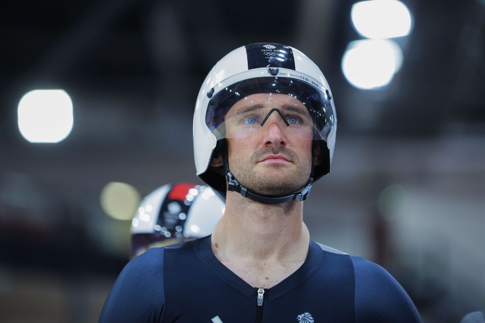 a man wearing a helmet with the olympics logo on it