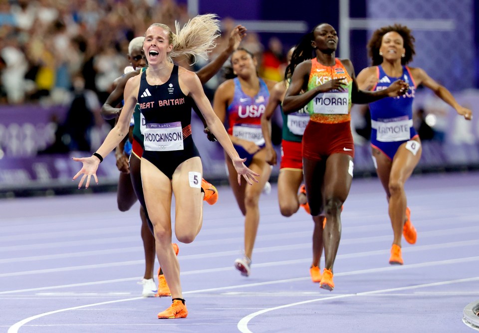 a group of female runners with one wearing the number 5