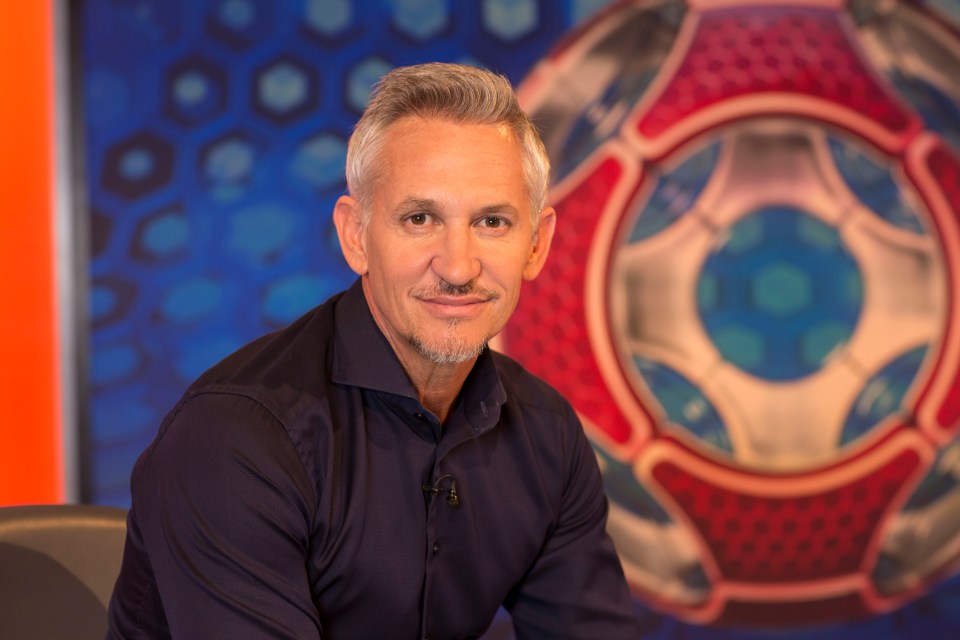 a man with a beard is sitting in front of a soccer ball