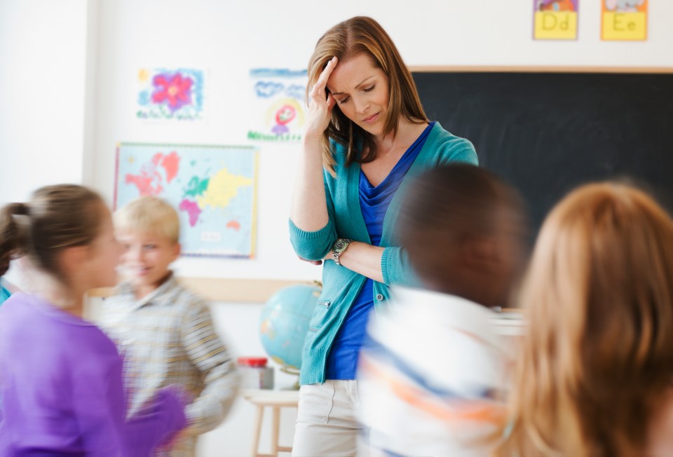 a teacher stands in front of a blackboard with the letters ea on it