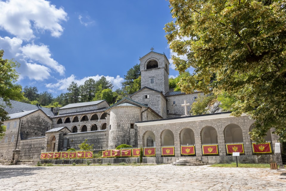 a large stone building with a cross on top of it