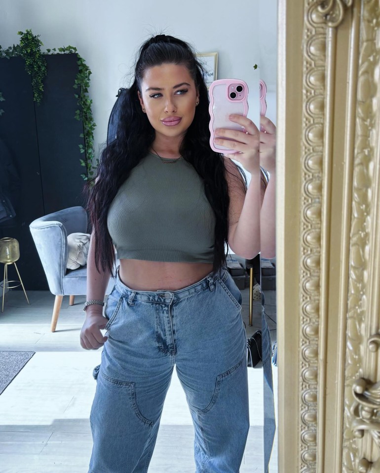 a woman taking a picture of herself in a mirror