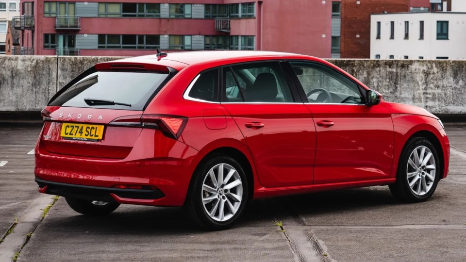 a red skoda car with a license plate that says cz74 scl