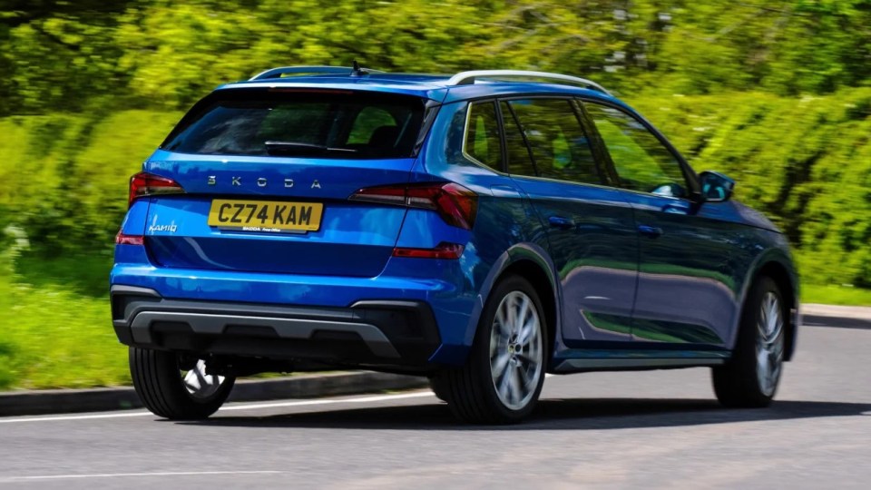 a blue skoda with a license plate that says cz74kam