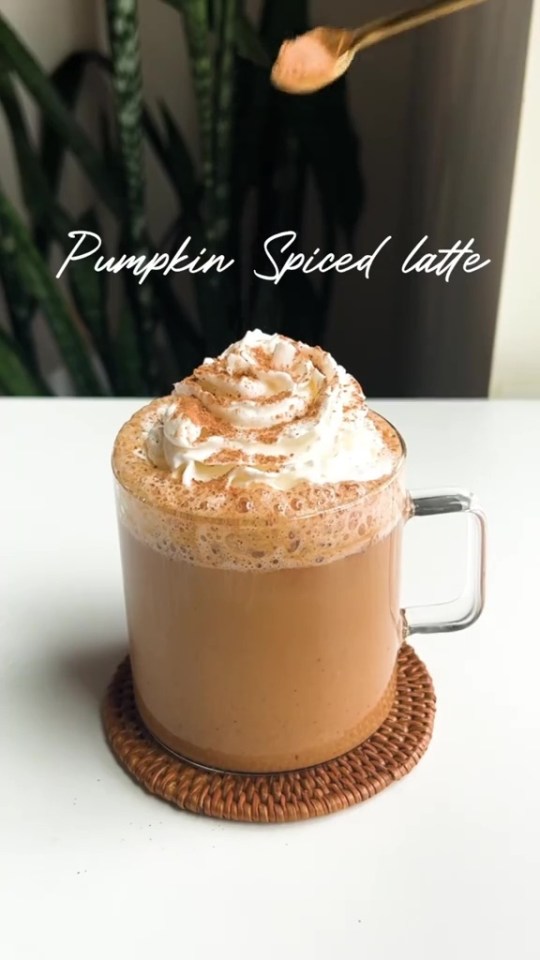 a cup of pumpkin spiced latte with whipped cream on top