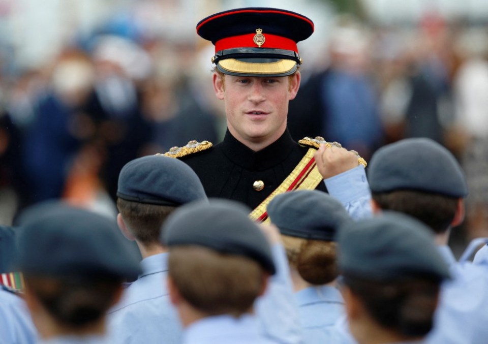 FILE PHOTO: Britain's Prince Harry speaks with cadets during a "Step Short" ceremony to mark the 100th anniversary of the outbreak of World War One (WW1), in Folkestone, in southern England August 4, 2014. REUTERS/Luke MacGregor/File Photo