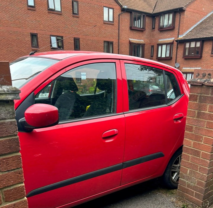 Car blocking an the footpath. Photo released September 5 2024. A disgruntled resident has taken to blocking a footpath with their car in a long-running row over primary school parking.A cul-de-sac in Bushey, Hertfordshire, has been in an ongoing feud with parents who use the private road to park when dropping their kids off at school. The Meadowcroft estate just off the high street is connected by a footpath to St Hildas Preparatory School, which makes it an ideal spot for parents to park- to the frustration of residents.Around 18 months ago, ANPR cameras were installed to discourage parents parking and £100 penalty charges started appearing in the post..