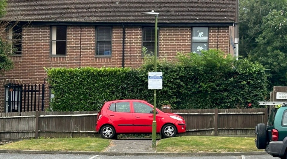 Car blocking the footpath. Photo released September 5 2024. A disgruntled resident has taken to blocking a footpath with their car in a long-running row over primary school parking.A cul-de-sac in Bushey, Hertfordshire, has been in an ongoing feud with parents who use the private road to park when dropping their kids off at school. The Meadowcroft estate just off the high street is connected by a footpath to St Hildas Preparatory School, which makes it an ideal spot for parents to park- to the frustration of residents.Around 18 months ago, ANPR cameras were installed to discourage parents parking and £100 penalty charges started appearing in the post..