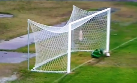 a soccer goal with a net that is broken in half
