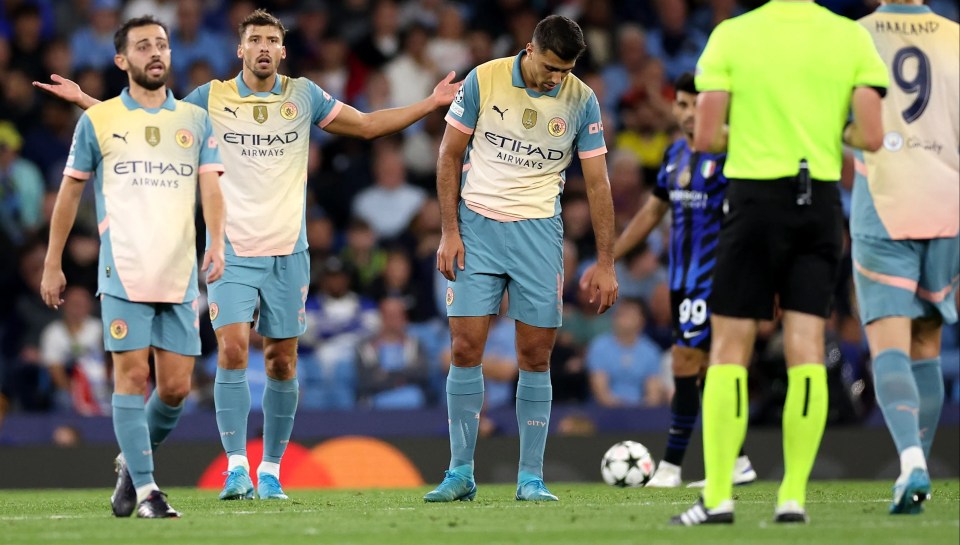 soccer players wearing etihad airways jerseys stand on the field