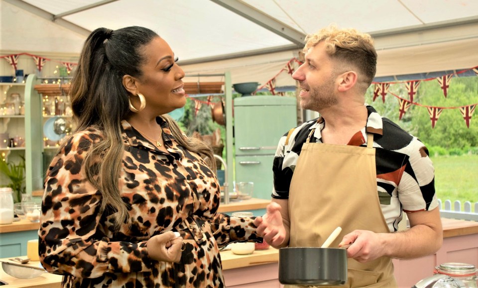 a man in an apron talks to a woman in a leopard print shirt