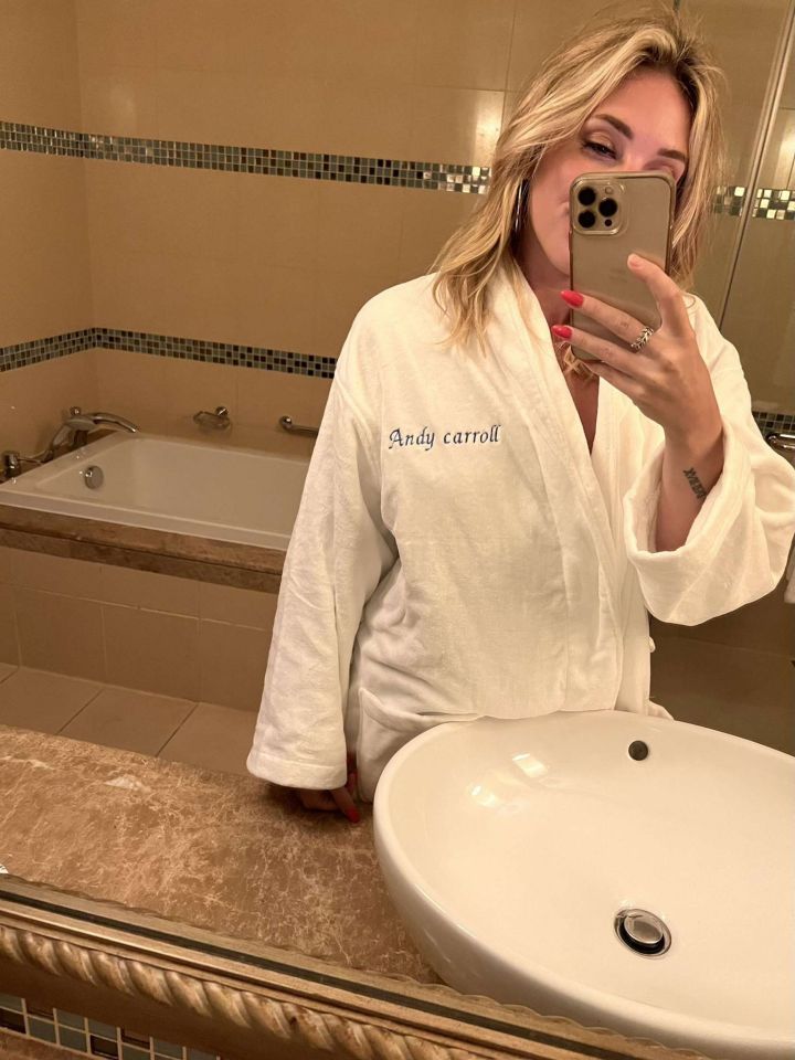 a woman in a bathrobe with the name andy carroll on it
