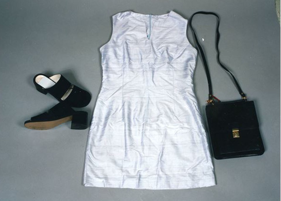 a white dress with black shoes and a black purse